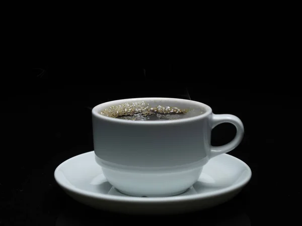 Warm cup of coffee with smoke on black background — Stock Photo, Image