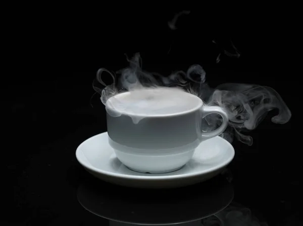 Warm cup of coffee with smoke on black background — Stock Photo, Image