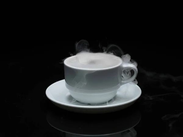 Warm cup of coffee with smoke on black background — Stock Photo, Image