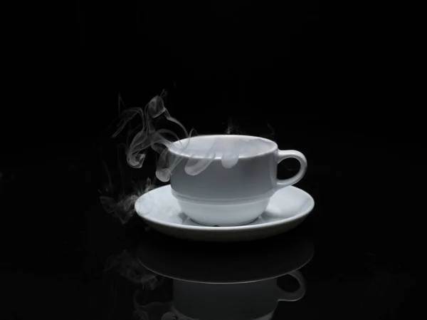 Warm cup of coffee with smoke on black background — Stock Photo, Image