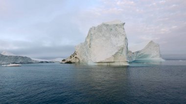Huge iceberg on arctic ocean in greenland clipart
