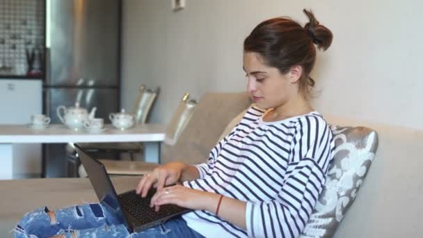 The girl is using laptop and is smiling — Stock Video