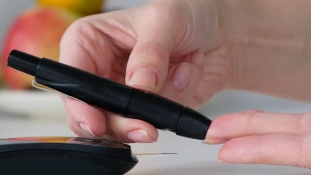 Woman Checking Blood Sugar Level At Home with glucometer, close up — 图库视频影像