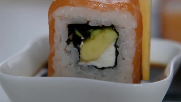 Concept de livraison de nourriture : quelqu'un trempera des sushis dans de la sauce soja, gros plan — Video