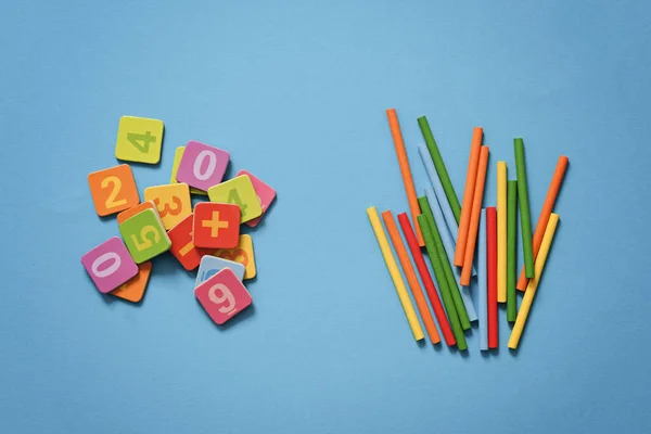 School background - numbers, counting sticks on blue background. Mathematics