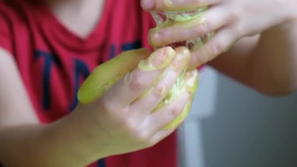 Little child boy toddler playing with light green slime — 비디오