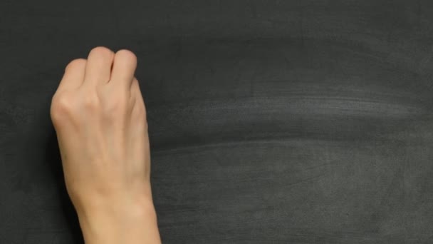 Fhysics teacher writing drawing the formula of conservation of energy on chalk board, close up. Mathematics and physics concept. — Stockvideo