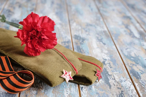 9 May holiday. Victory Day background - George ribbon, red flowers carnation. — Stock Photo, Image