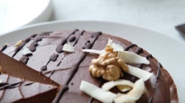 Ev yapımı çiğ vejetaryen pastası. Hindistan cevizi sütü, tereyağı, kaju, kakao ve cevizden yapılmış sağlıklı bir tatlı. Kapat.