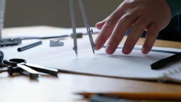 Architects desk: drawings, compass, ruler and other drawing tools. Engineer works with drawings, close-up. — Stock Video