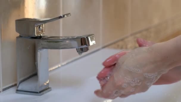 Woman washing hands at the wash basin with foam, cleanse the skin from viruses. Pandemia of corona virus — Stock Video