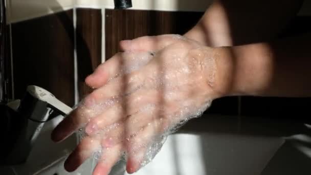 De mens wast de handen bij de wastafel met schuim, reinigt de huid van virussen. Pandemie van het coronavirus — Stockvideo
