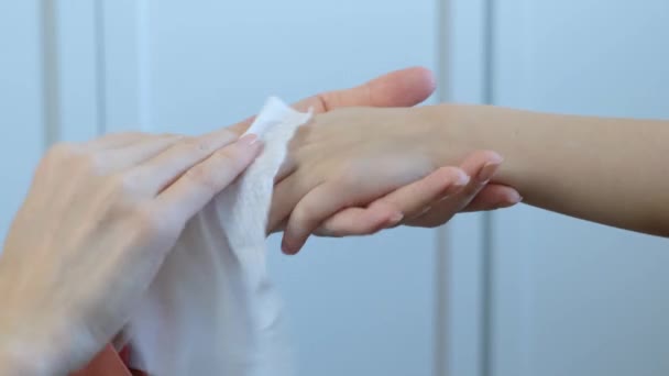 Child hygiene: woman using wet antiseptic wipe to clean childs hands, protecting from viruses and bacteria, close up — Stock Video