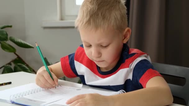 Kind jongen peuter hand doet eenvoudige wiskunde oefeningen, close-up. Wiskundeconcept — Stockvideo