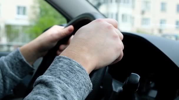 Man driving a car, holding a wheel. Hands close up — Stock Video