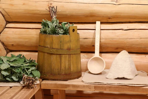 In the Russian bath on the bench are bath utensils and a barrel for steaming broom.