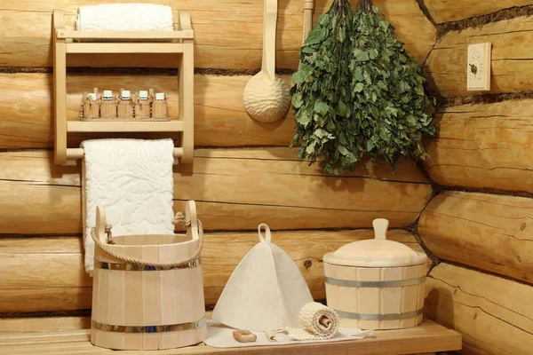 Part of the interior of the Russian bath and bath accessories. Bath accessories on the background of the log walls of the Russian bath.