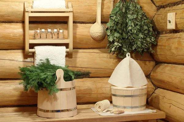 Part of the interior of the Russian bath and bath accessories. Bath accessories on the background of the log walls of the Russian bath.