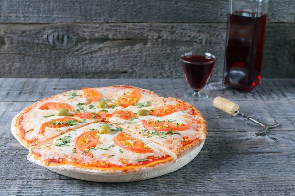 Pizza Pomidorami Kieliszek Czerwonego Wina Butelką Szarym Drewnianym Tle — Zdjęcie stockowe