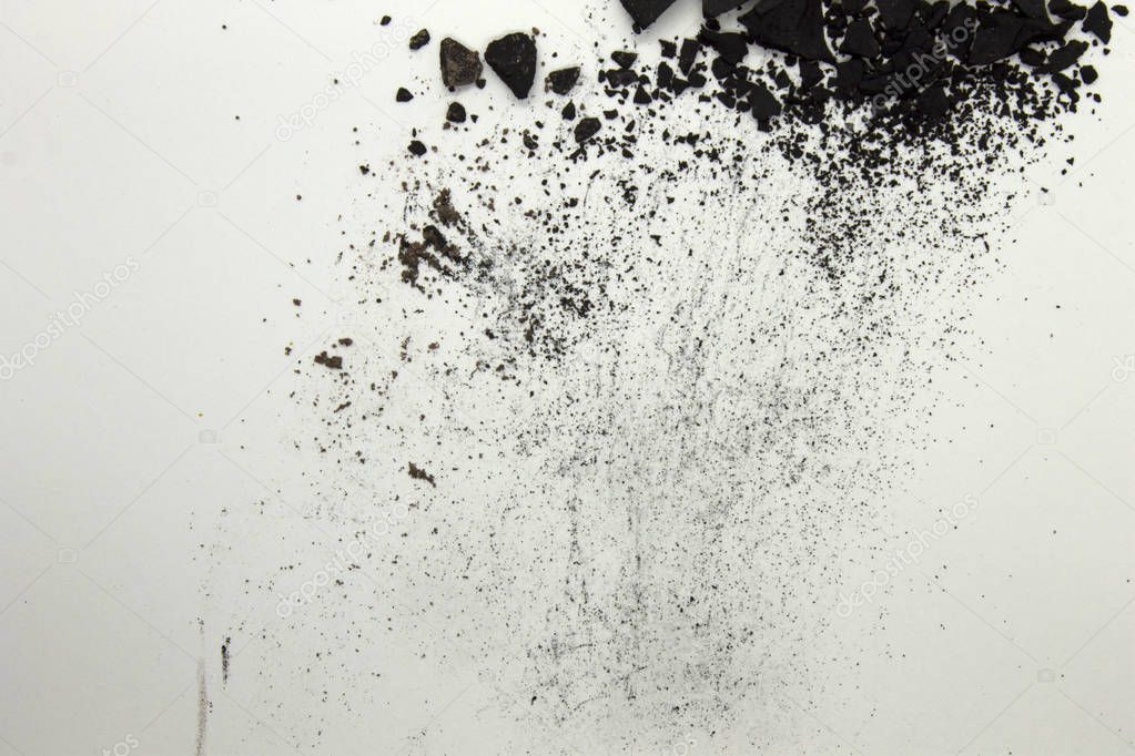 This is a photograph of a Black powder Eyeshadow isolated on a White background