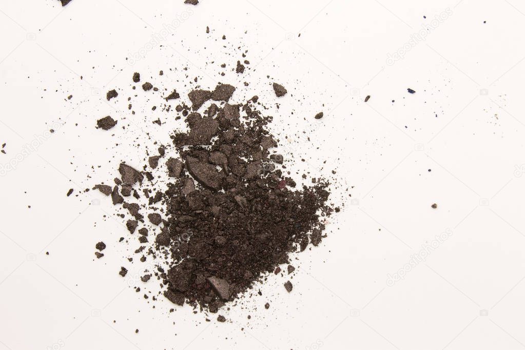 This is a photograph of a dark Brown powder Eyeshadow isolated on a White background