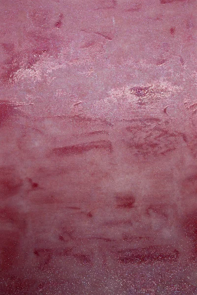 This is a photograph of a shiny Pink Lip gloss swatch background