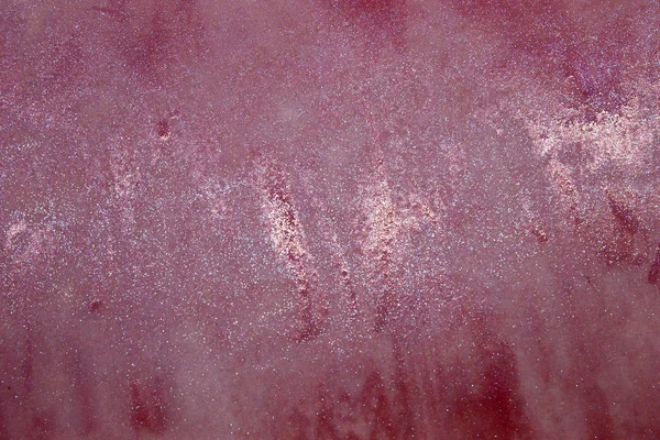 This is a photograph of a shiny Pink Lip gloss swatch background