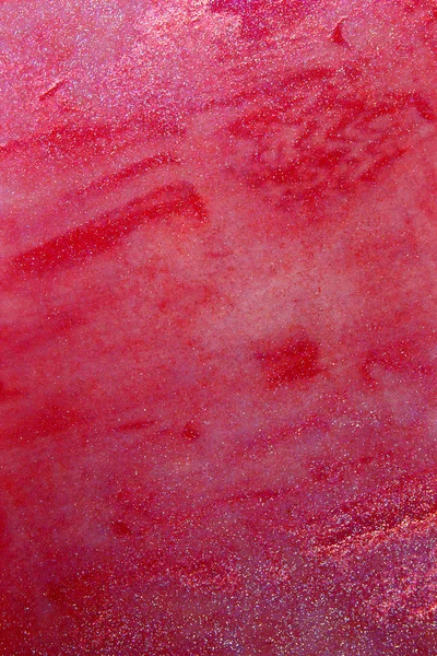 This is a photograph of a Red Lip gloss swatch background