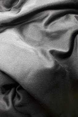 Bu desenli siyah kumaş arkaplanının bir fotoğrafı.