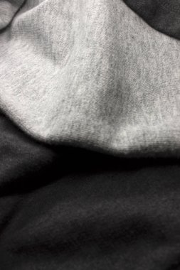 Bu, Koyu ve Açık Gri kumaş arka planının bir fotoğrafı.