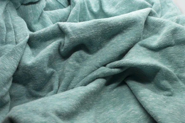 This is a photograph of textured Turquoise fabric
