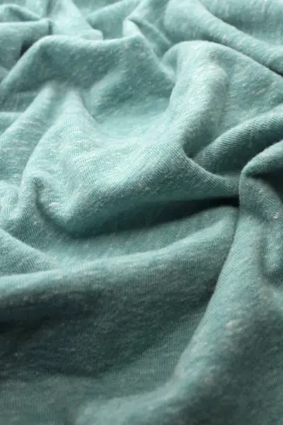 This is a photograph of textured Turquoise fabric