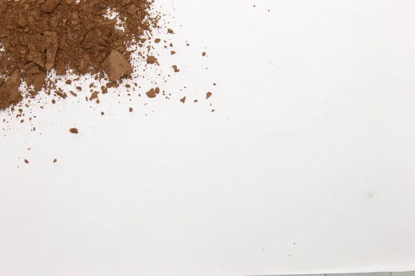 This is a photograph of a Matte Brown Powder Eyeshadow isolated on a White Background