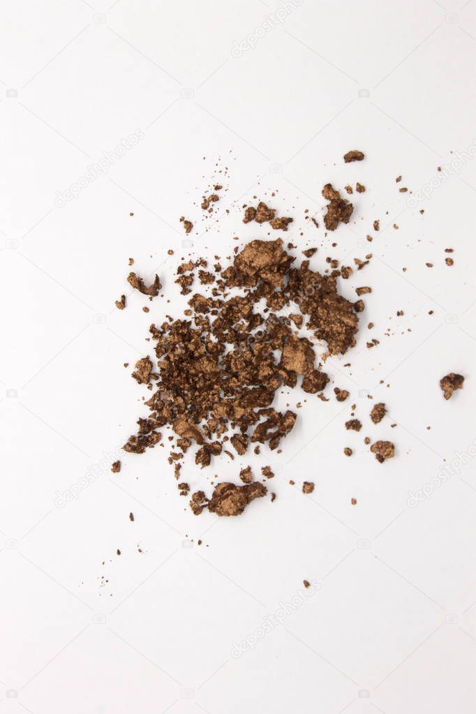 This is a photograph of a Metallic Bronze Powder Eyeshadow isolated on a White Background 