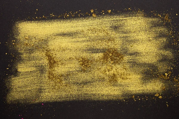 Bu, altın tozu Eyeshadow 'un siyah arka planda izole edilmiş bir fotoğrafı.