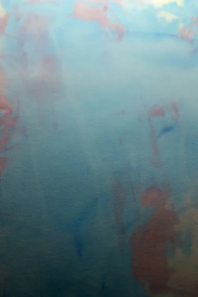 This is a photograph of a Blue, Pink and Yellow abstract background created using watercolours