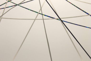 Bu, beyaz bir kağıda uygulanan siyah, gri bantla yaratılmış geometrik bir tasarımın fotoğrafı.