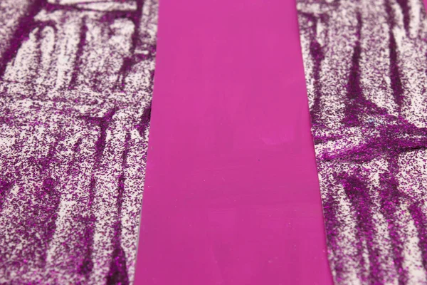This is a photograph of an abstract background created by organizing stripes created using Purple glitter paint and Fuschia Pink acrylic paint
