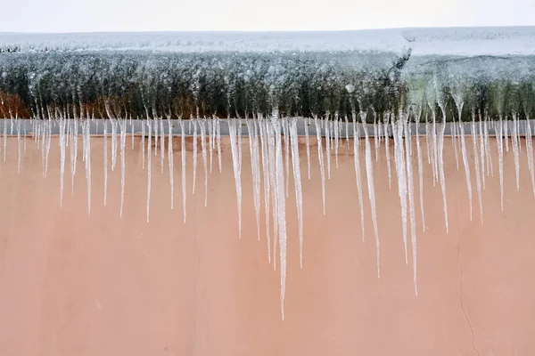 Dangerous icicles on the house roof — Stock Photo, Image