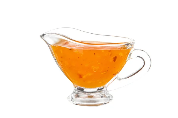 Glass sauceboat with orange ketchup Stock Image