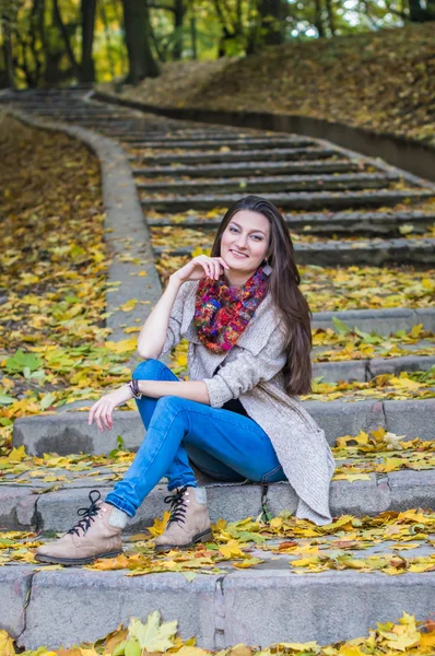Chica sonriente sentada en las escaleras — Foto de Stock