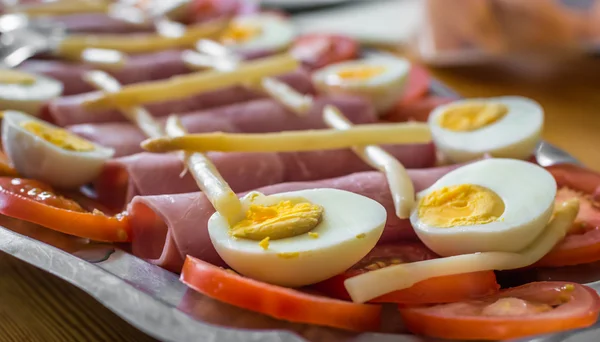 Huevos medio cocidos, tomates en rodajas, jamón y espárragos — Foto de Stock