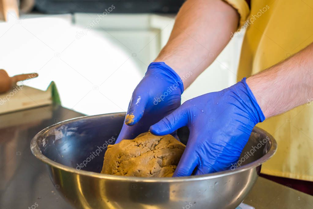 Hands knead dough with gloves Stock Photo by ©okskukuruza 128861766