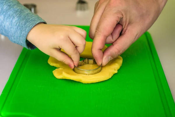 Criança e pai faz cortadores de biscoitos de massa — Fotografia de Stock