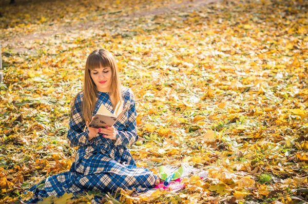 girl reading book in park