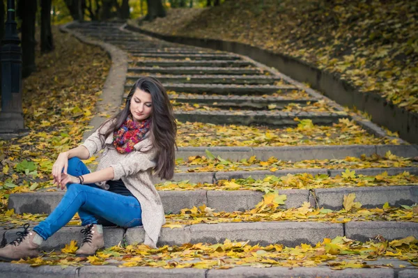 Girl sitting on stone steps — Stock Photo, Image
