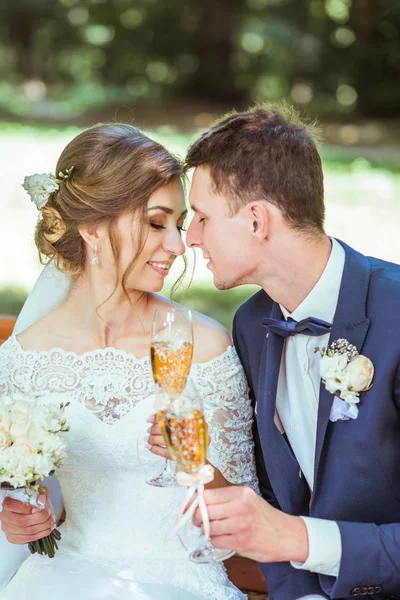 Groom and bride sits in the park