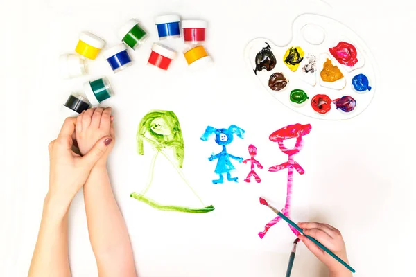 Childs hands painting a family — Stock Photo, Image