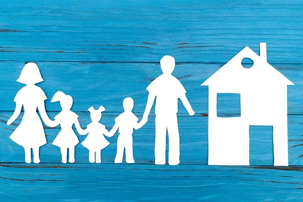 Closeup of happy paper family on blue background — Stock Photo, Image