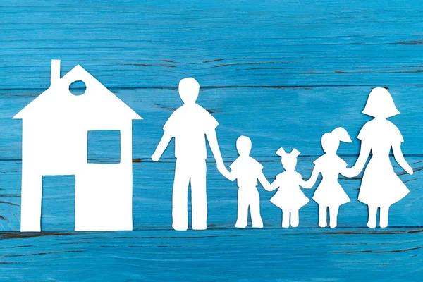 Крупный план счастливой семьи бумаги на синем фоне — стоковое фото